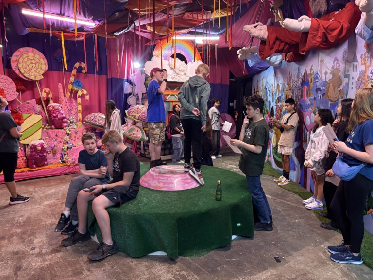 A group of students look around at creative art structures